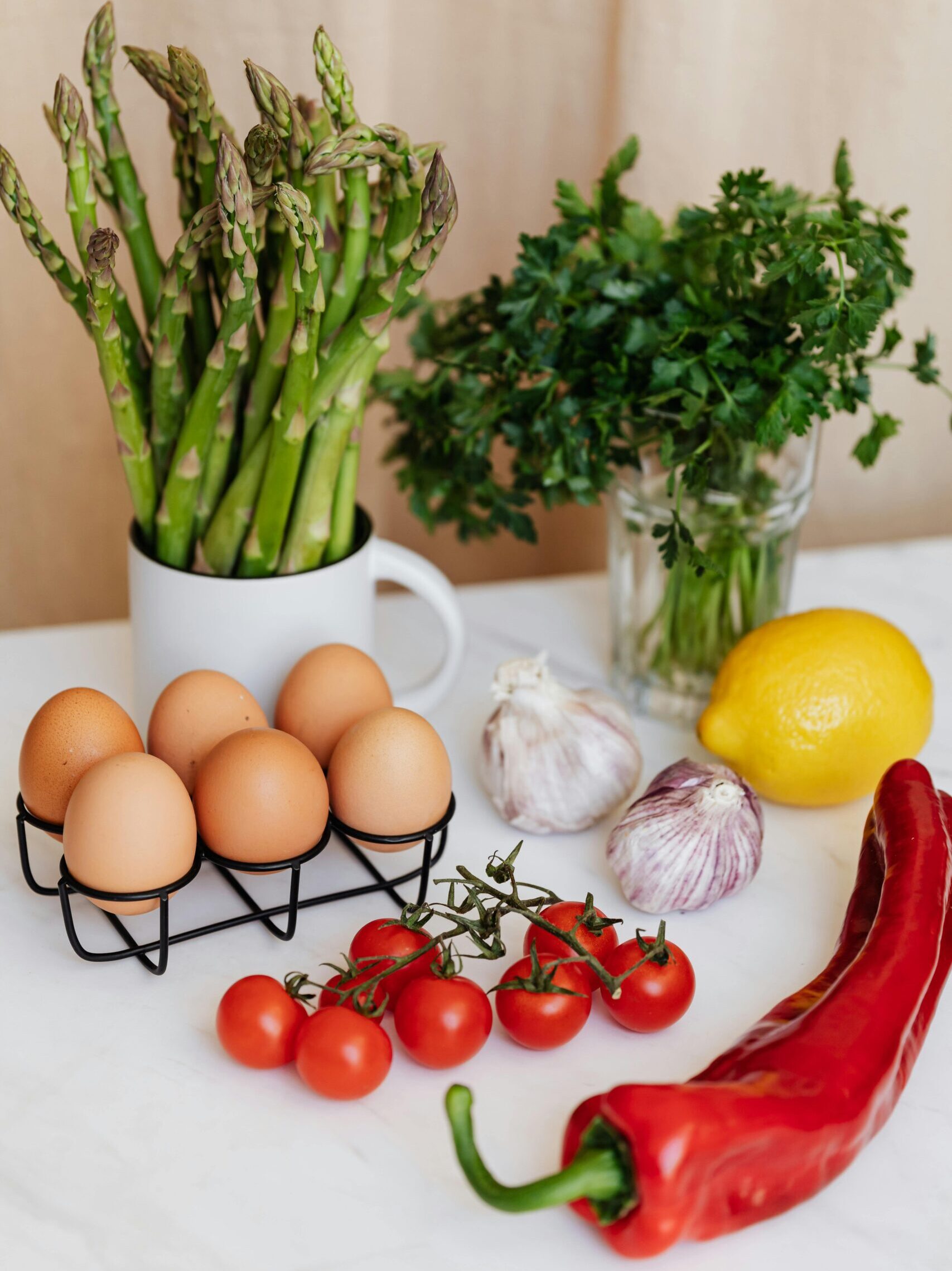 A selection of fresh ingredients including asparagus, eggs, and more for healthy cooking.